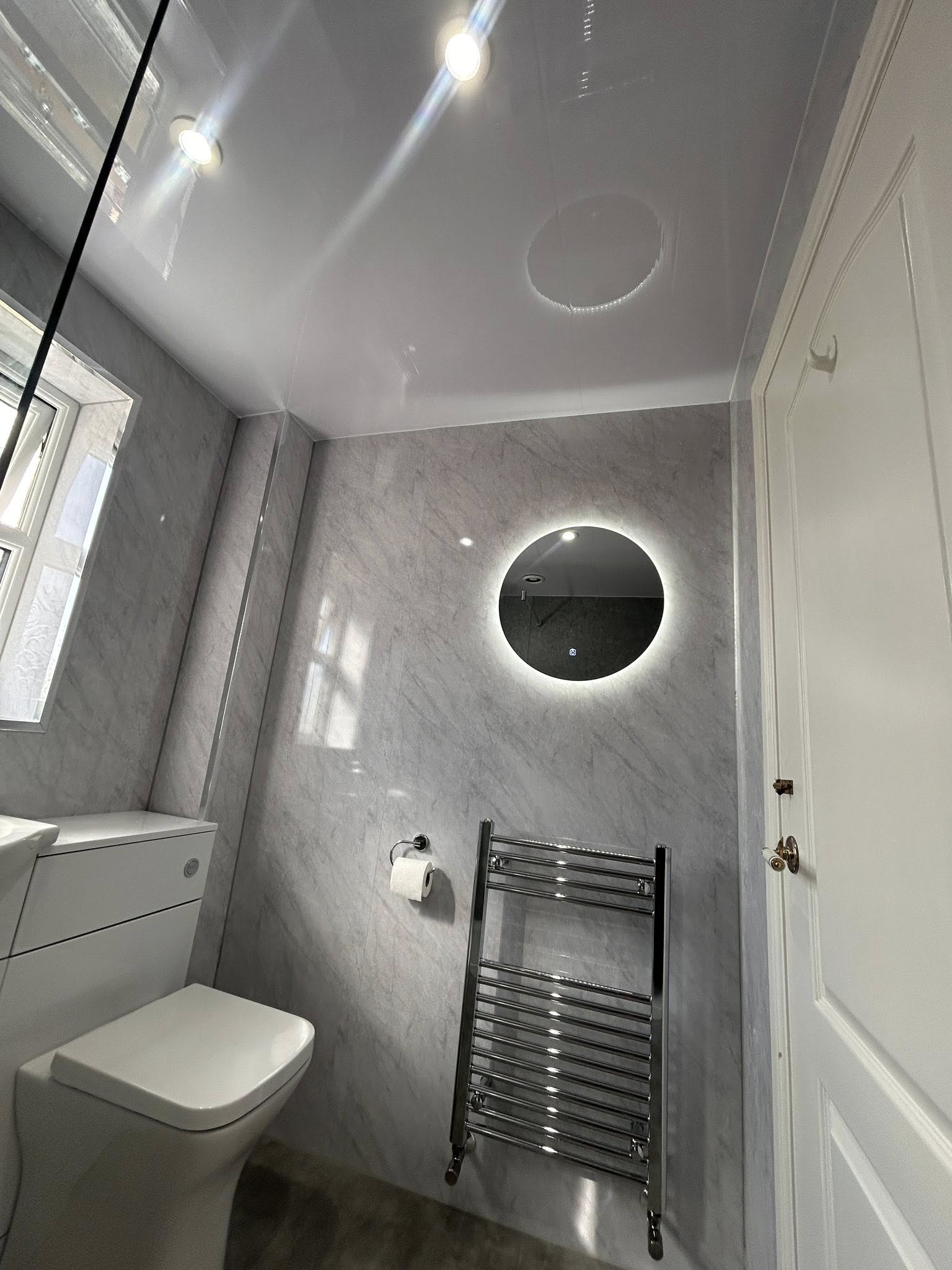 Bathroom with plaster walls and black vanity